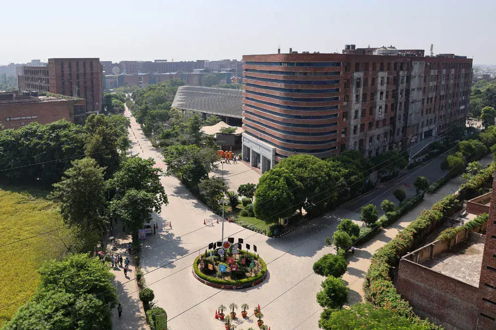 Tree-lined main road and buildings on the LPU campus