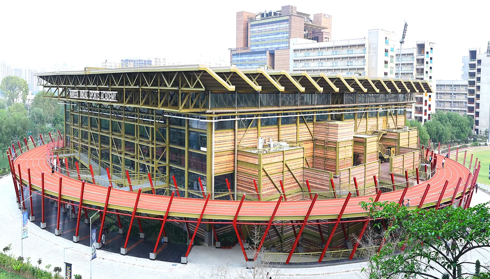 Sports academy building with its red running track at O.P. Jindal Global University