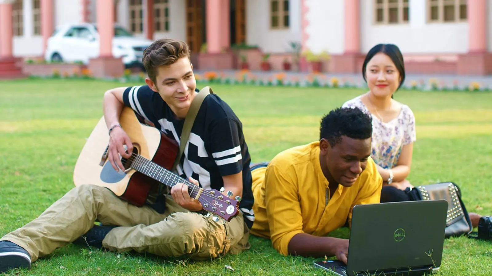 Students relaxing on the campus lawn at Uttaranchal University