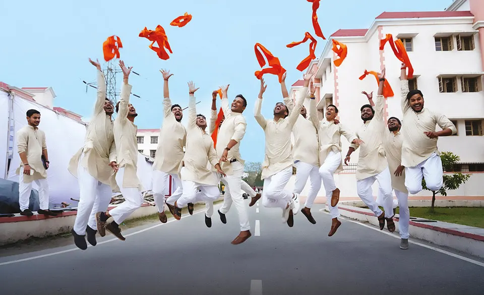 Students celebrating on a campus road at Uttaranchal University