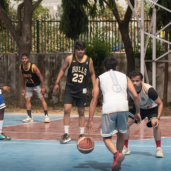 Students playing basketball at the VGU sports arena